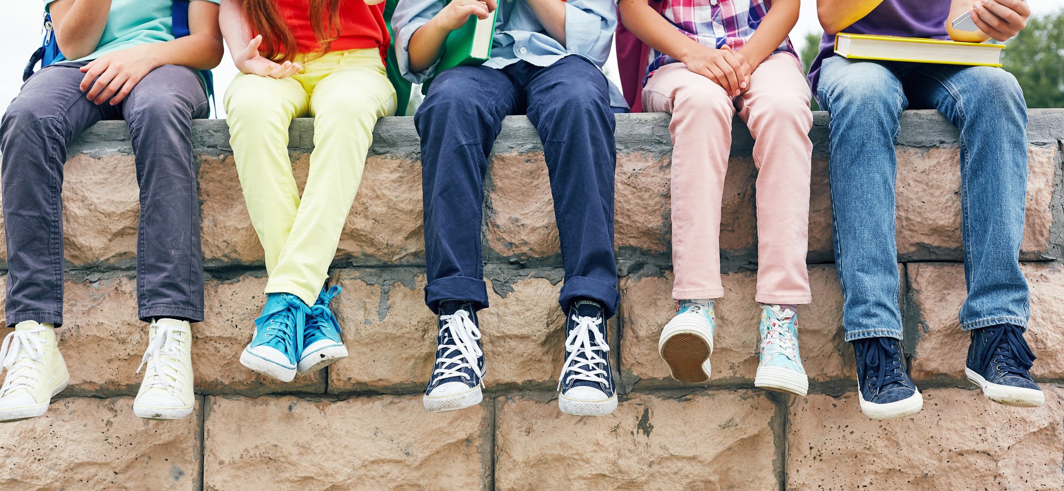 Row of successful learners looking at camera outside